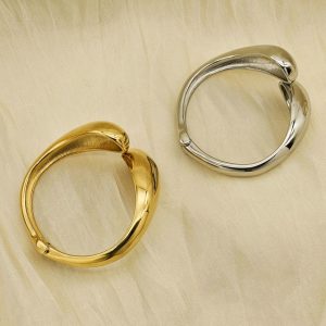 Geometric, glossy cross stainless steel bangle with asymmetric droplet double-headed design in INS style.